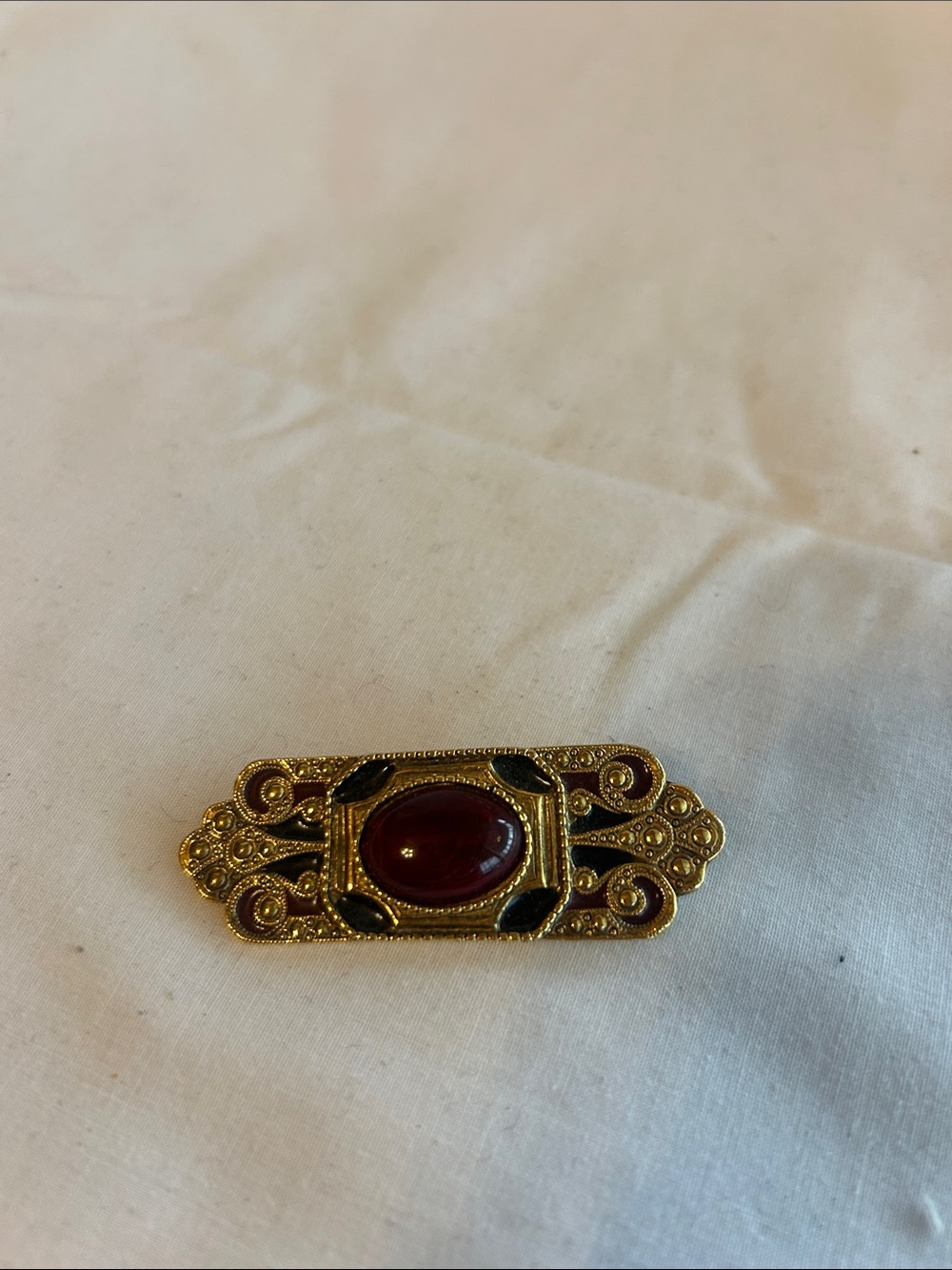 Source Unknown Gold Tone Brooch with Red Cabochon and Black Accents